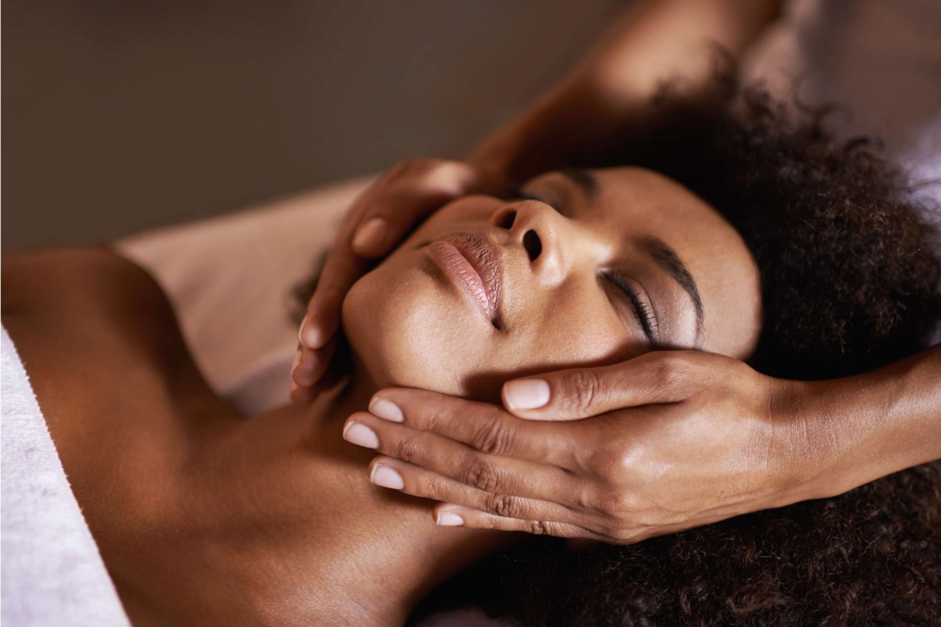 A woman with her eyes closed enjoying a facial